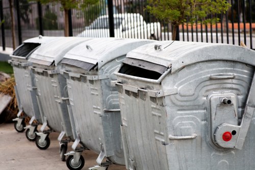 Fleet vehicle and crew preparing for waste collection at a commercial site